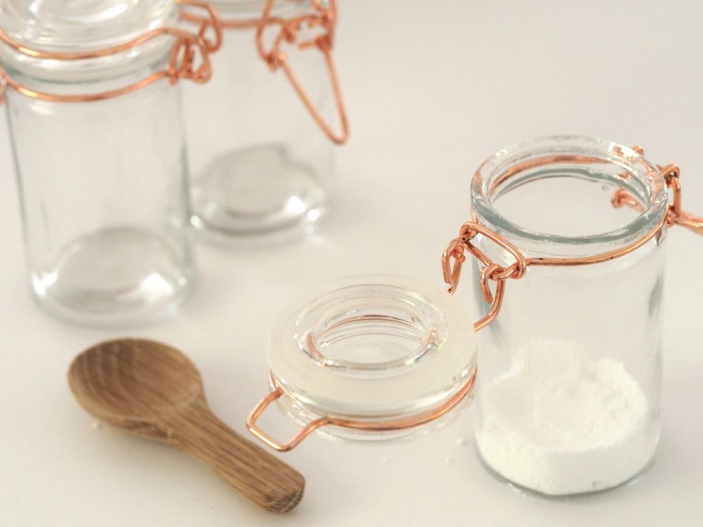 sugar in jar with wooden spoon